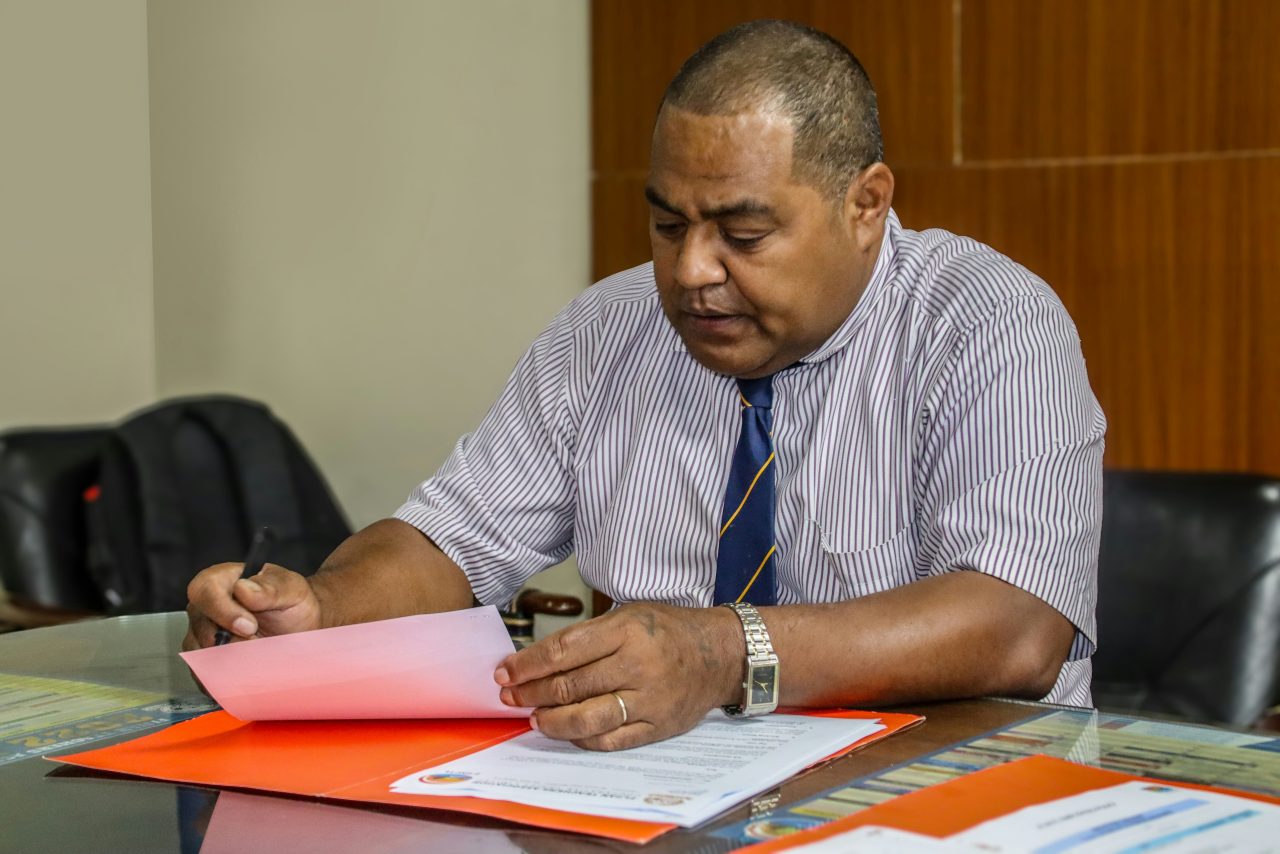Immigration lawyer in Brisbane reviews official papers to help clients understand what’s an “associated entity” under the ICT exemption